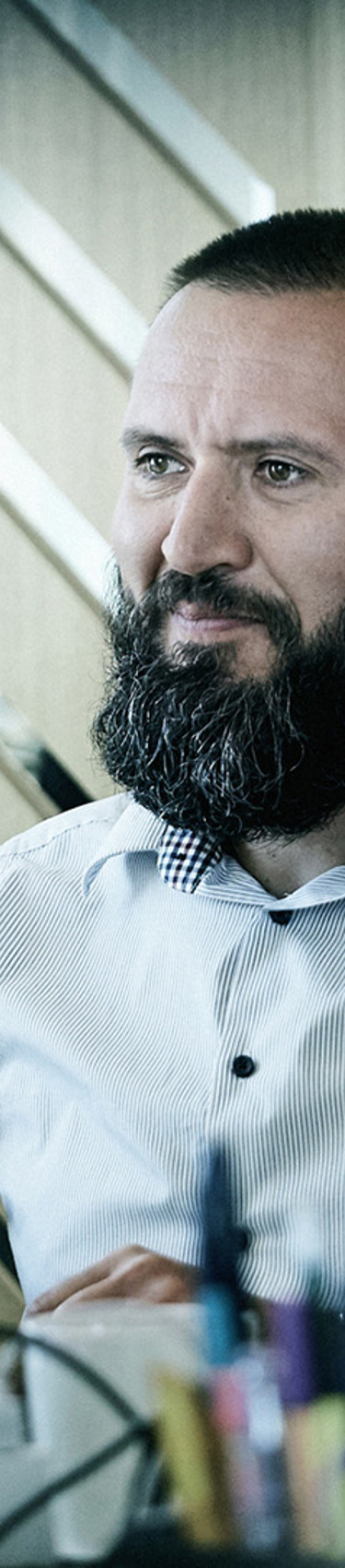 A man looking at a computer while working at the office 