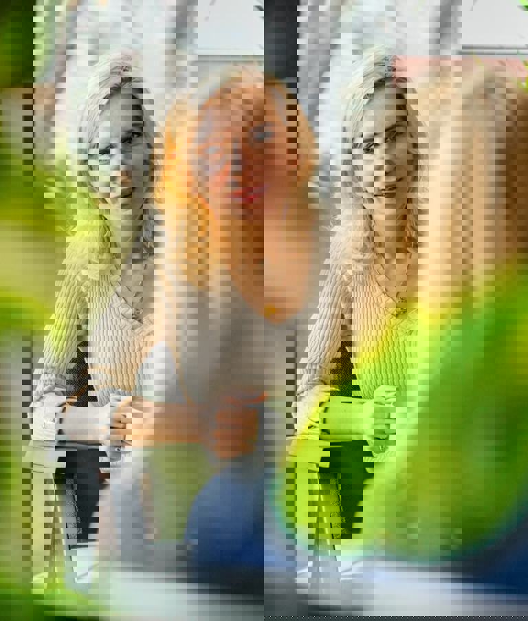 Two women talking with plants in the foreground