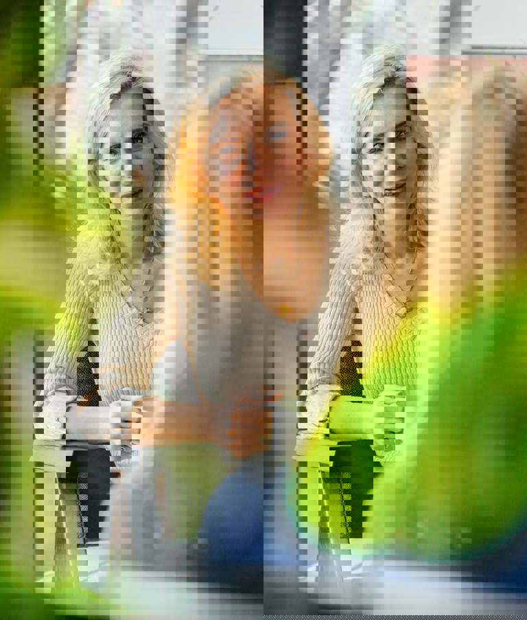 Two women talking with plants in the foreground