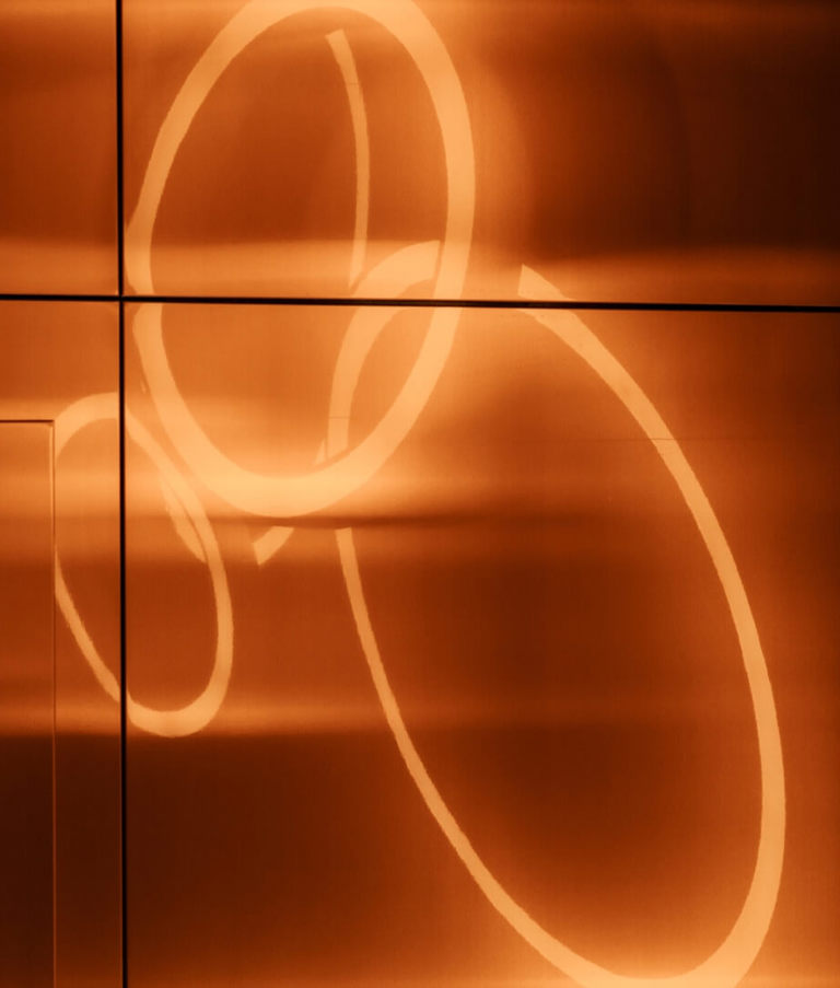 Orange light circles on a wall 