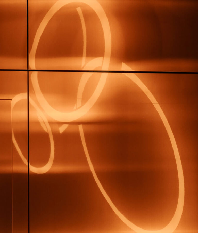 Orange light circles on a wall 