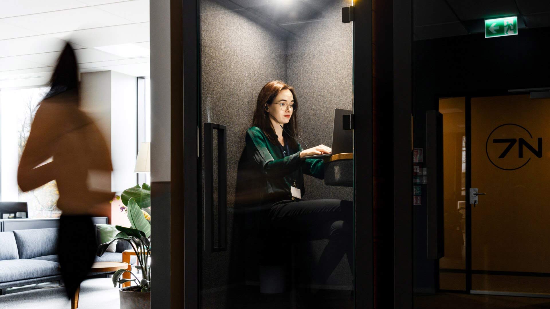 A woman working in the Gdańsk office in Poland, focused on her computer