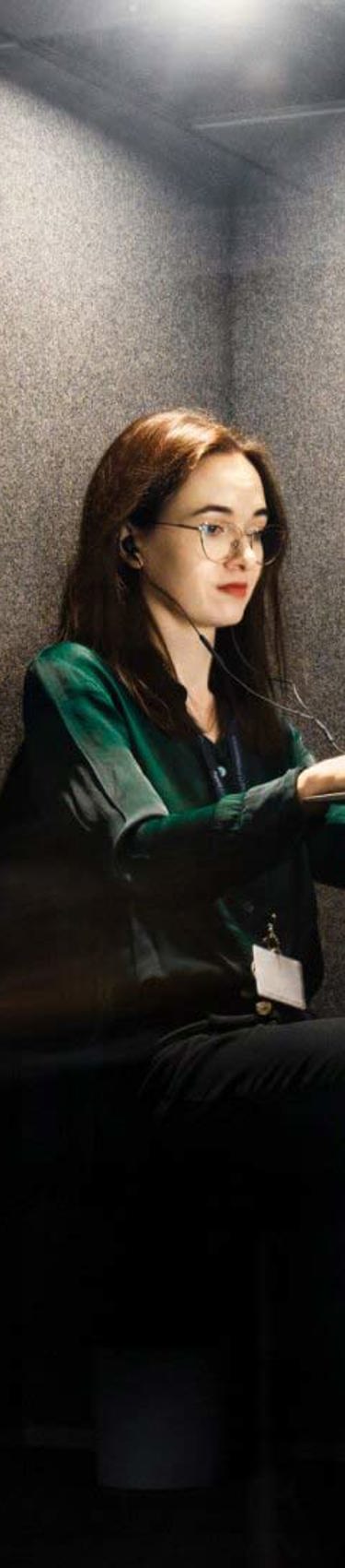 A woman working in the Gdańsk office, focused on her computer