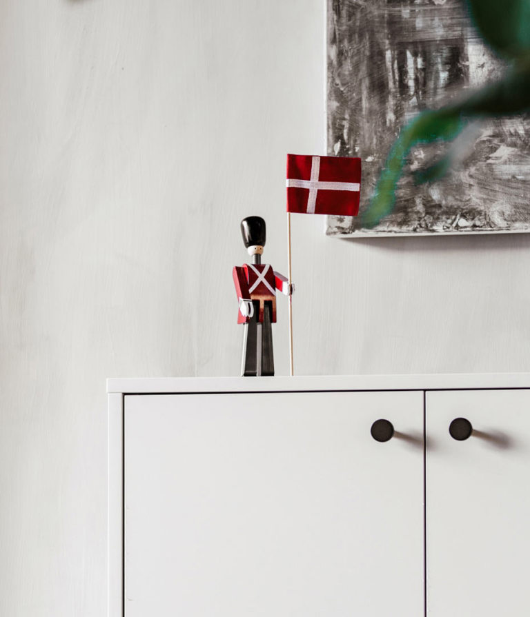 Small toy soldier with a Danish flag on a white counter in the Aarhus office, Denmark