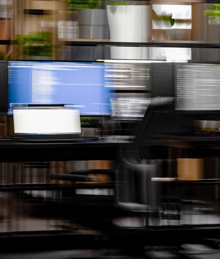 Blurred picture of man working at computer