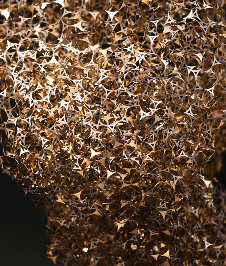 Dark background with golden sculpture in the front