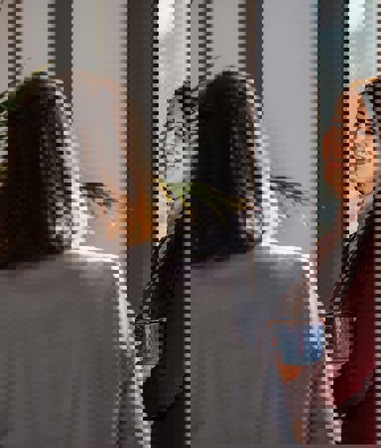 Women talking and smiling in a 7N office