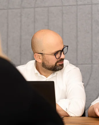 Man at computer looking to the side