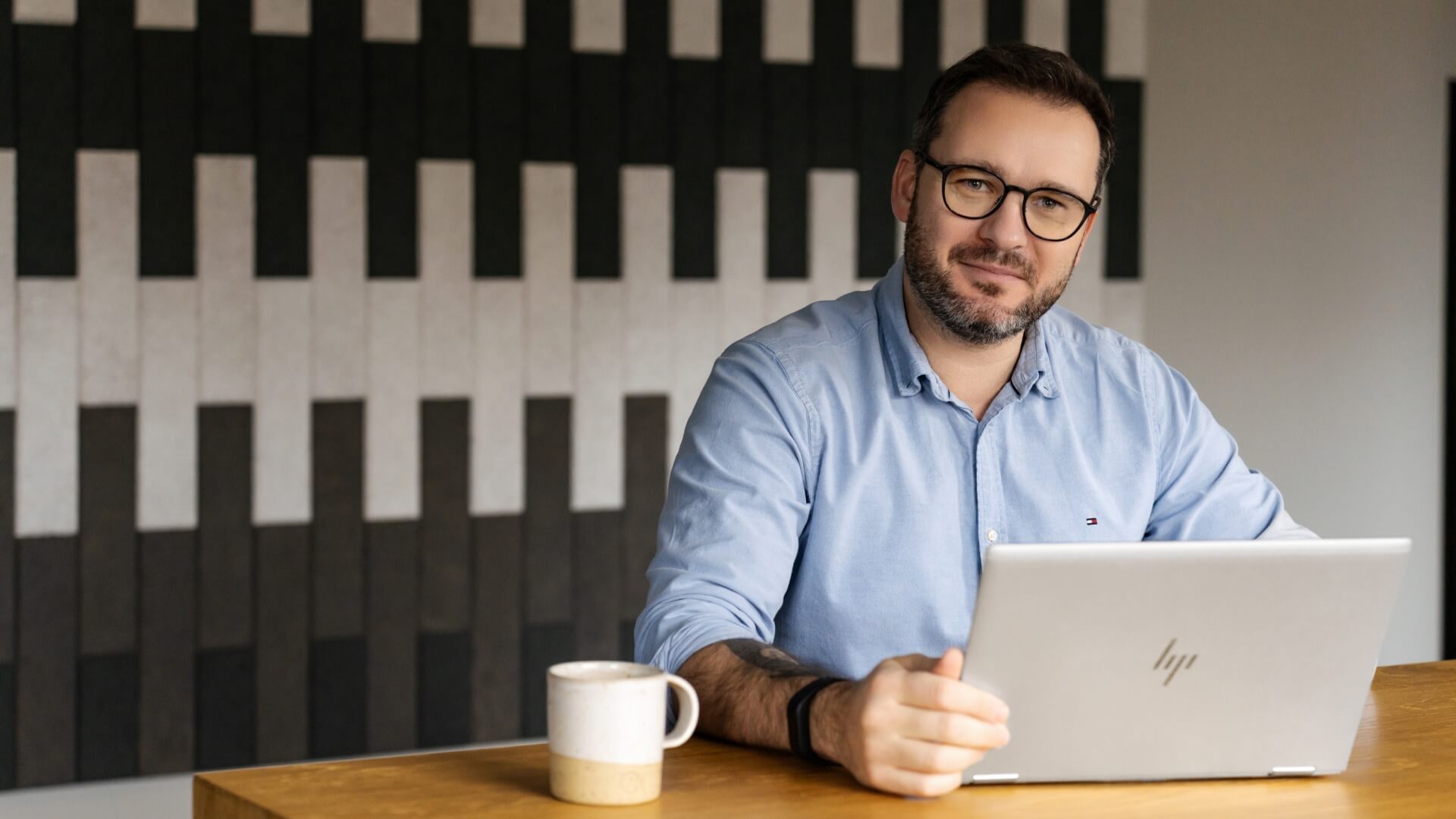 Man sitting in an office with a computer in the Warsaw office in Poland. 