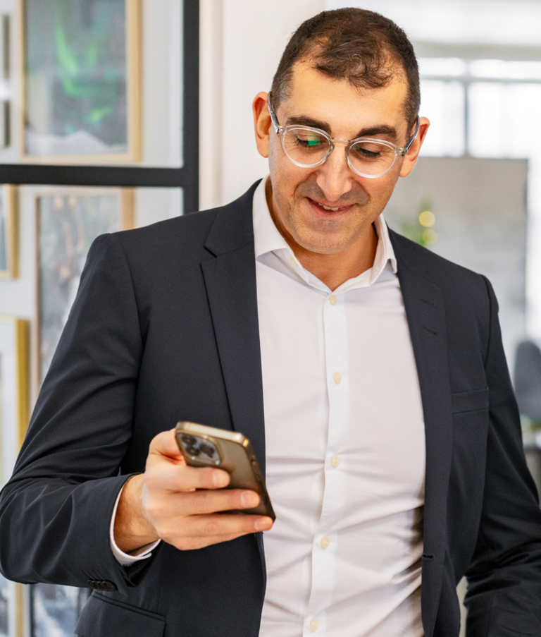 Two men looking at phone in the Copenhagen office in Denmark. 