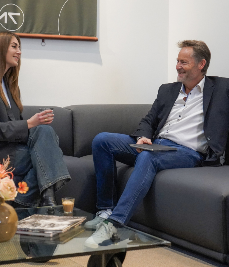 Two people talking in sofa