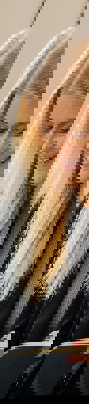 Woman in sofa writing notes in book