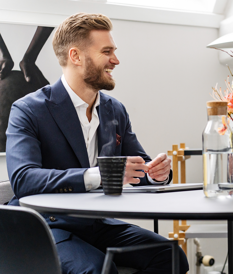 A man and woman sitting beside a black table during a meeting