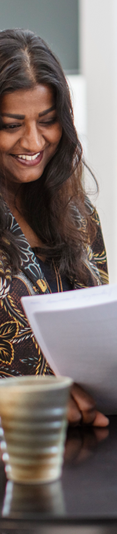 Two 7N employees smiling while looking at a consultant CV in the Copenhagen office in Denmark. 