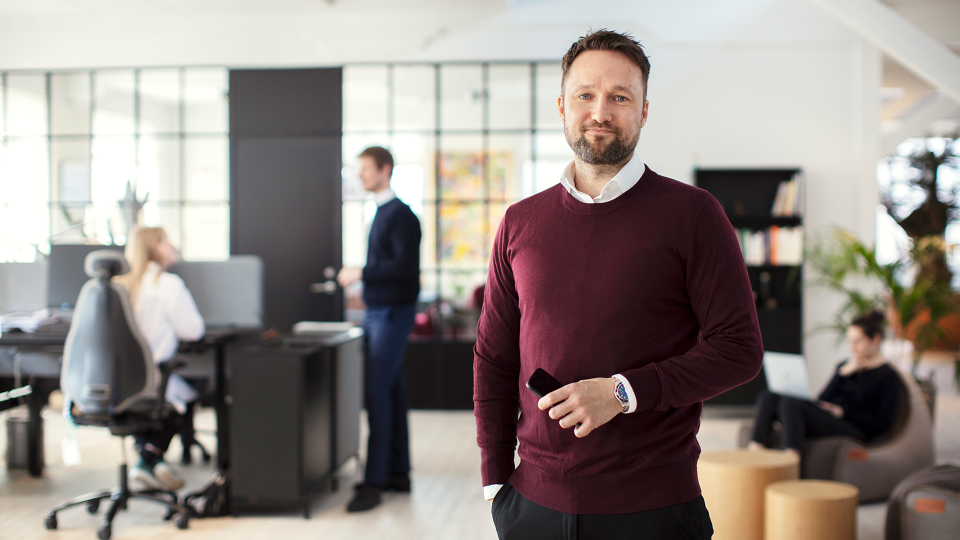 A 7N employee looking at the camera while standing in the Copenhagen office in Denmark 