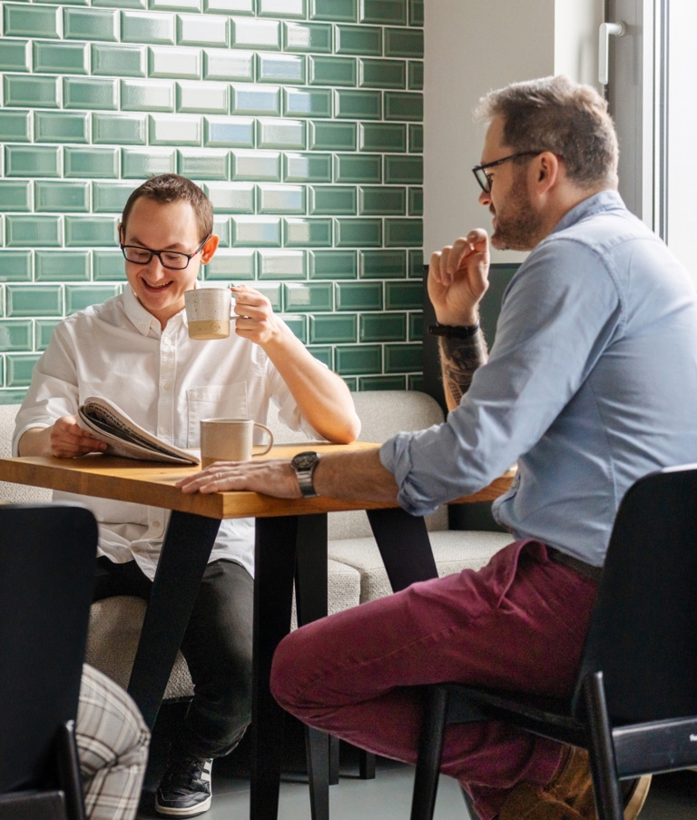 Four people talking while taking a coffee break in the Warsaw office in Poland.  