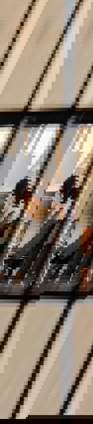 Woman working at office seen through squares