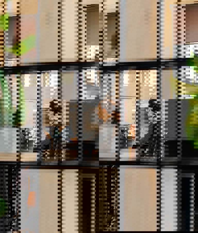 Woman working at office seen through squares