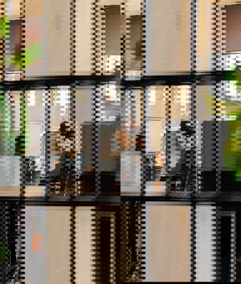 Woman working at office seen through squares