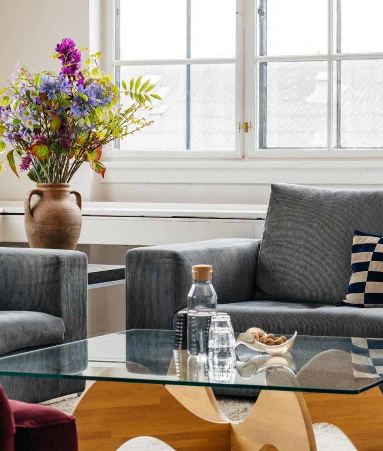 7N office with a glass table filled with a water bottle and cups 