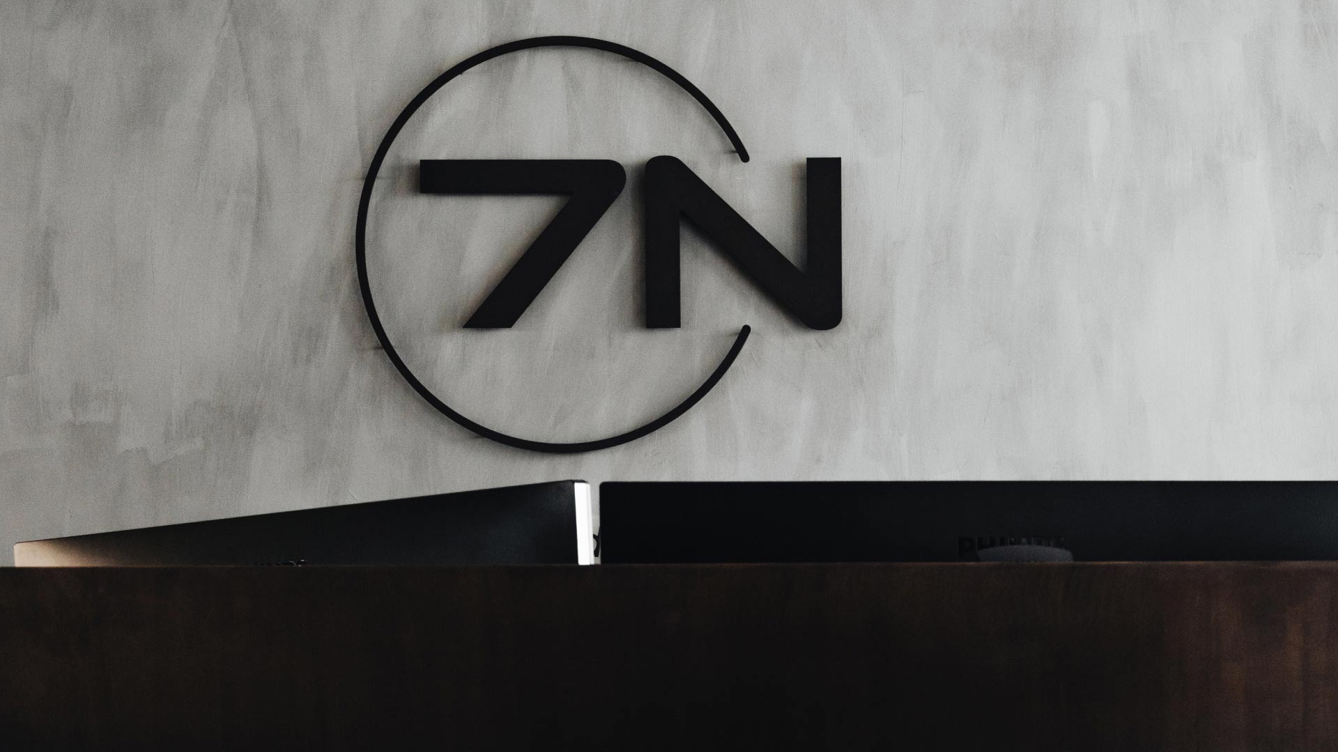 7N logo on a grey wall in the Aarhus office in Denmark. 