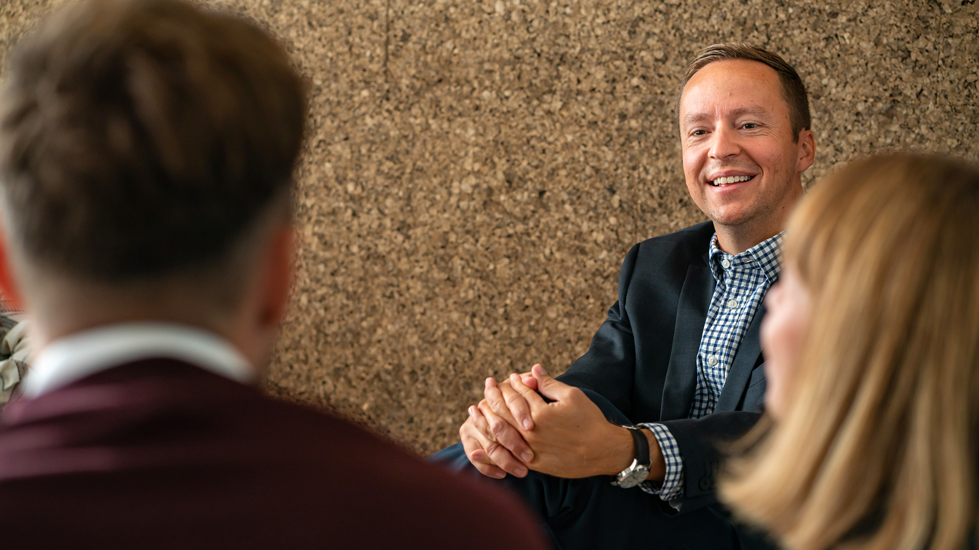 A man smiling during a meeting with two people in the Copenhagen office in Denmark 