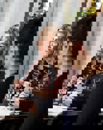 People sitting around a table in the Copenhagen office in Denmark during a meeting.