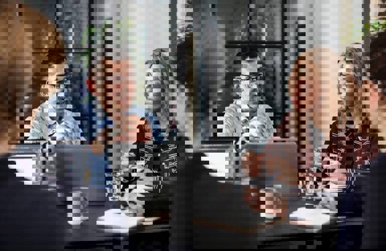 People sitting around table in the Copenhagen office during a meeting