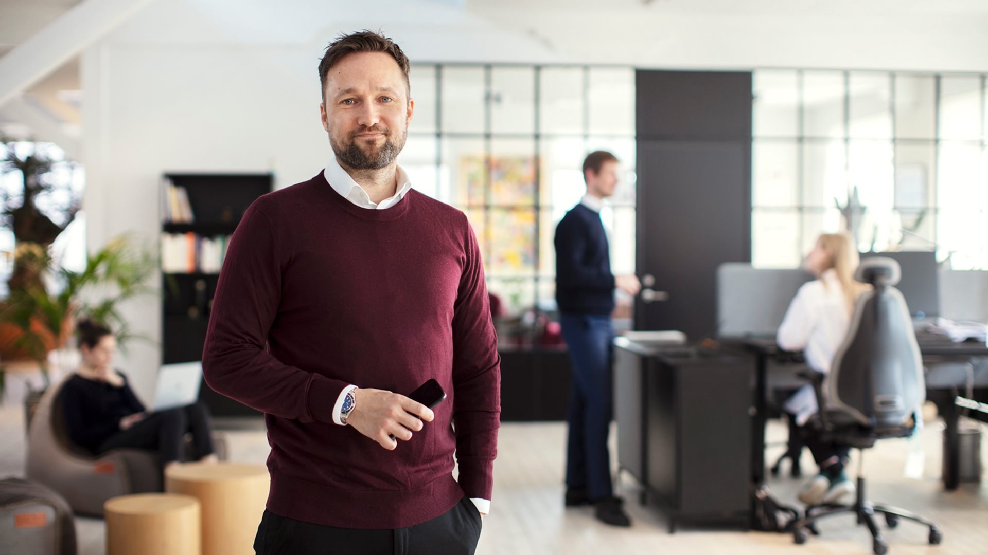 A 7N employee looking at the camera while standing in the Copenhagen office in Denmark  