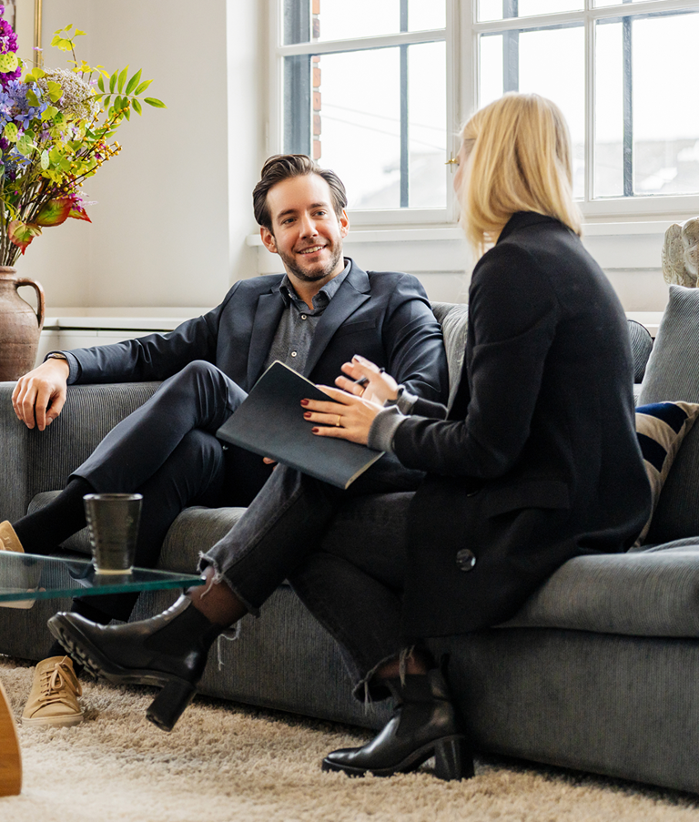 Two men and a woman talking while sitting in sofas in the Copenhagen office in Denmark