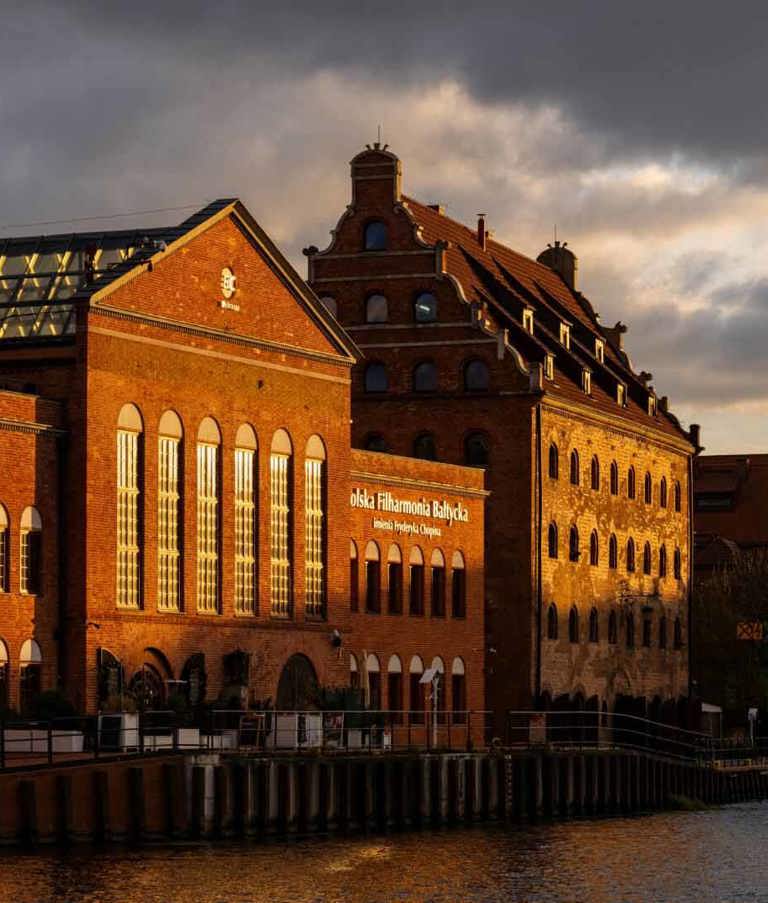 Buildings in sunlight by the water in Gdansk in Poland. 
